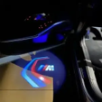 Automotive welcome lighting projecting a brand logo beside the car door