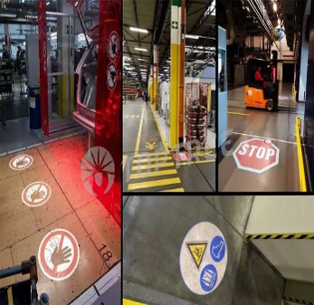 Industrial safety projections marking hazards and walkways on factory floors
